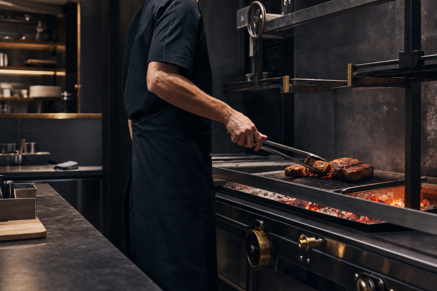 Chef tending steaks over live charcoal