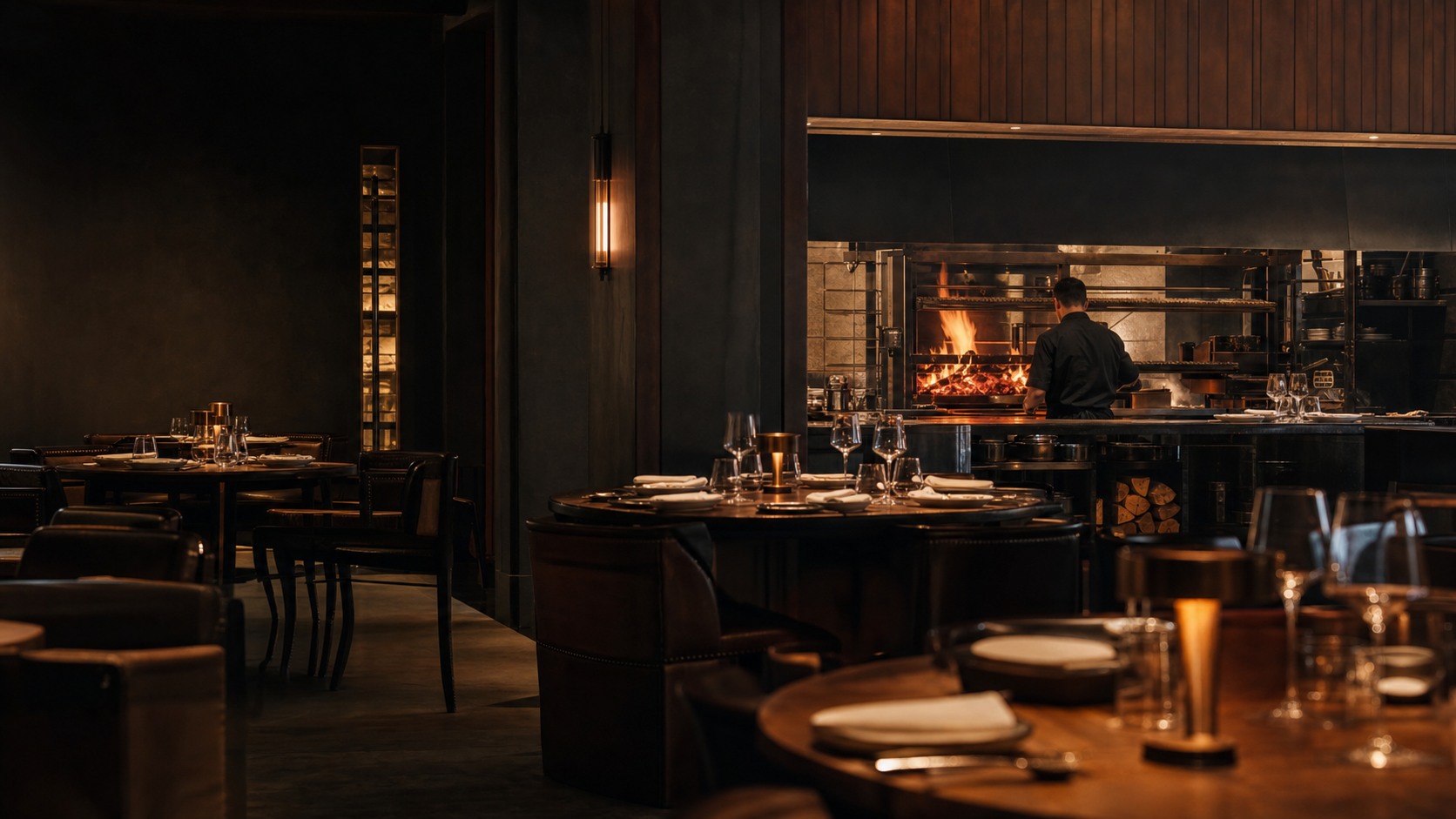 Refined steakhouse dining room with open charcoal grill